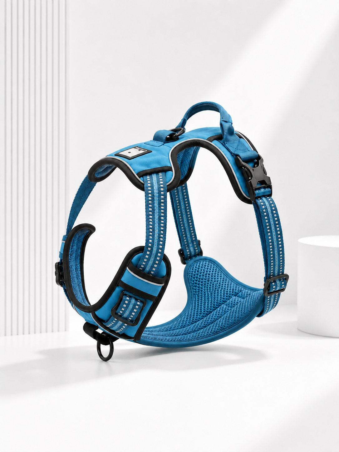 blue and black adjustable no-pull dog harness on a medium dog