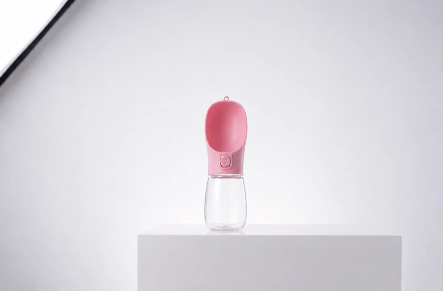 Pink portable dog water bottle with built-in drinking bowl
