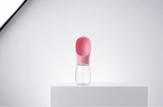 Pink portable dog water bottle with built-in drinking bowl