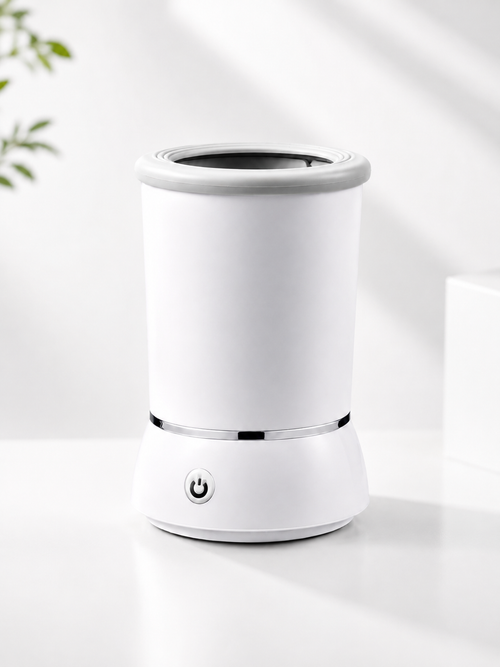 A white Portable Dog Paw Cleaner with a power button on the front base, set on a clean white surface with soft shadows.